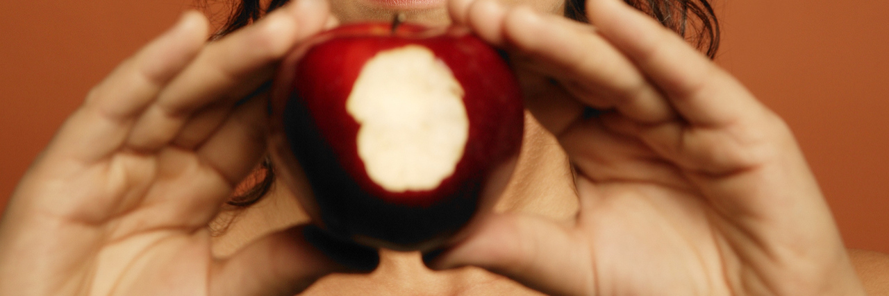 For the People Who Say Orthorexia Isn’t Really a Disorder woman holding an apple