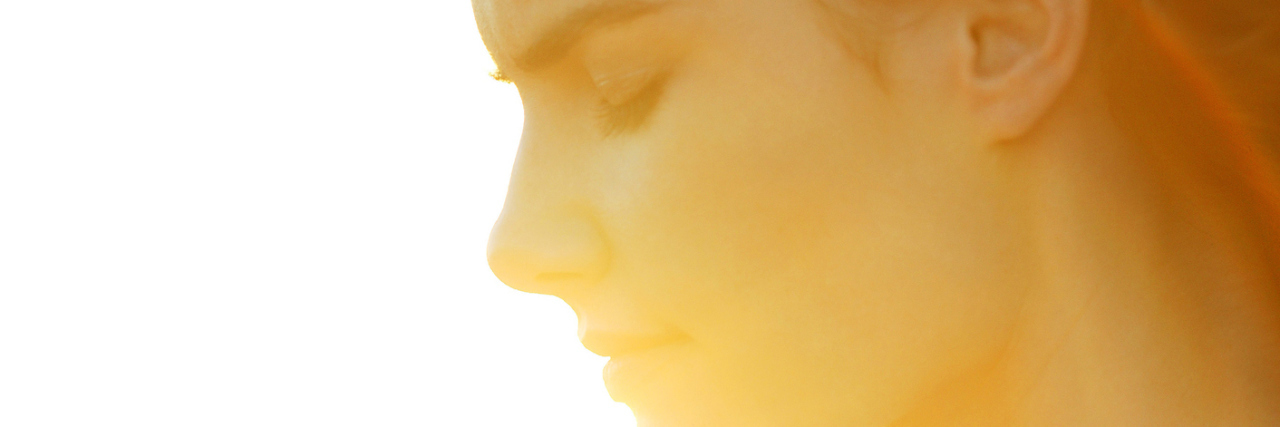 The Invisibility of Asperger's Syndrome Woman with hands cupped in sunlight.