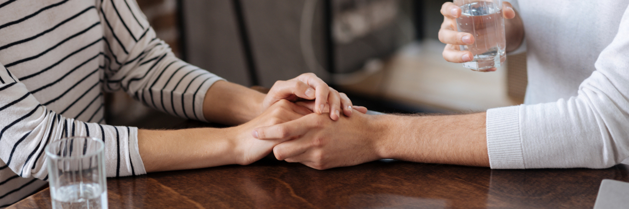 What I Need My Boyfriend to Know About My Depression couple holding hands across table