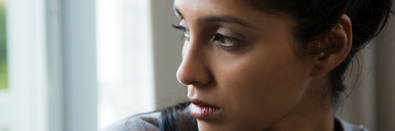 Bronchiectasis: When Friends Think You Look 'Fine' Despite Illness woman looking out the window over her shoulder