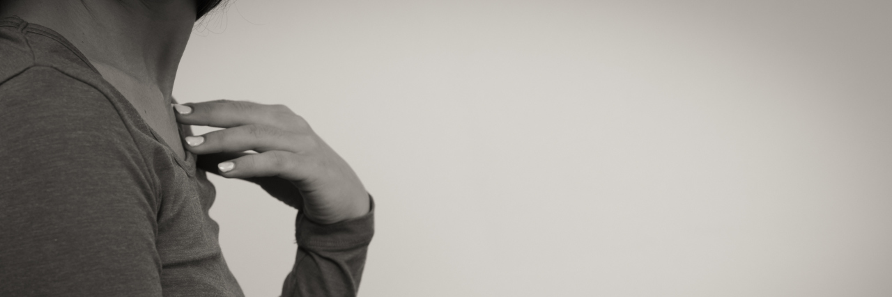 How the Stigma Against Personality Disorders Nearly Killed Me black and white image of side view young woman with hand to chest