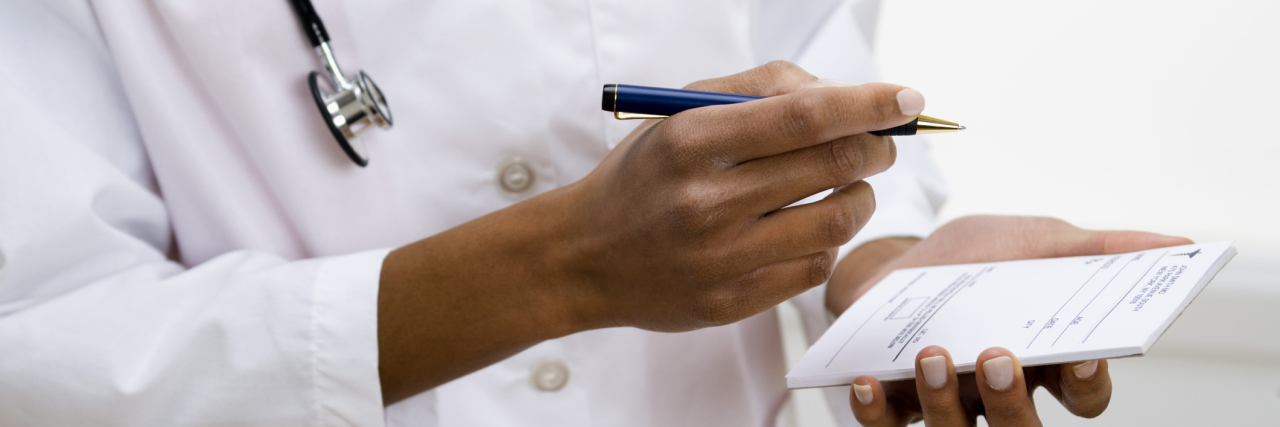 Juvenile Idiopathic Arthritis: Doctors Not Asking About Mental Health doctor writing prescription