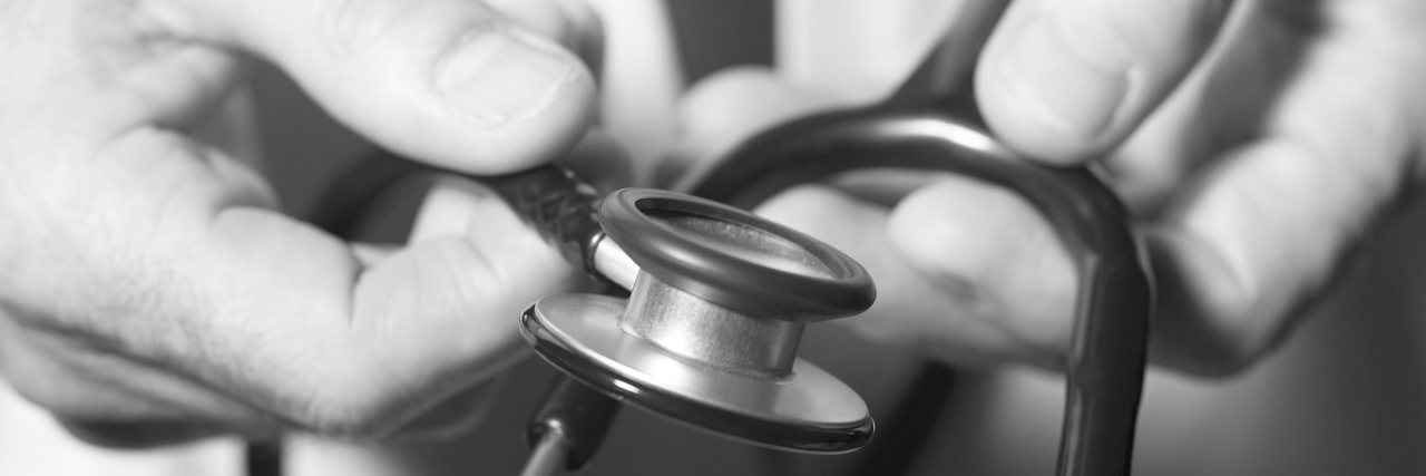 Close-up of doctor's hands on stethoscope