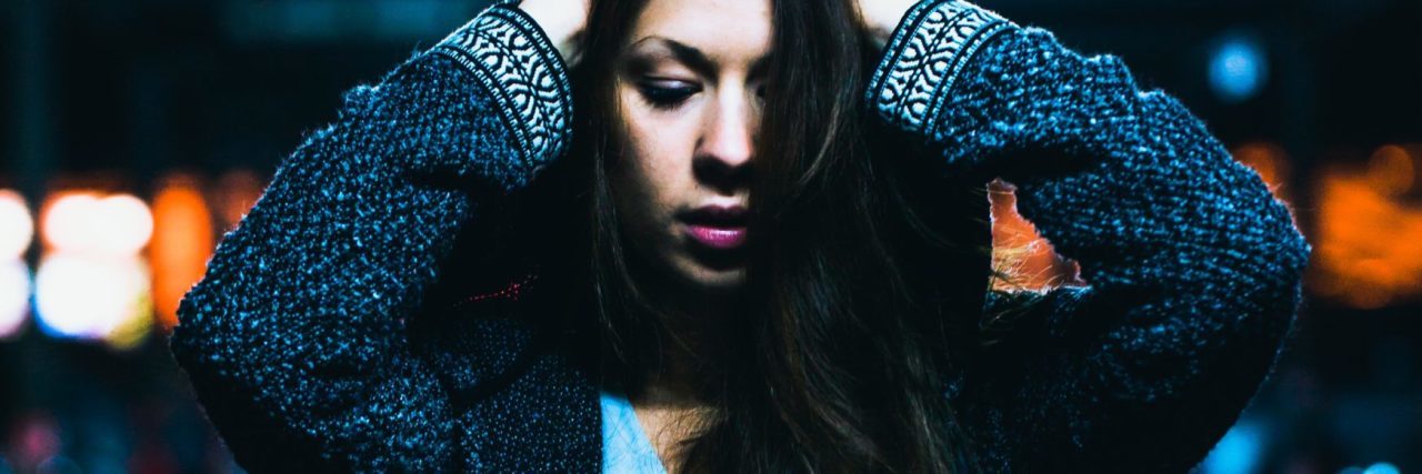 How It Feels to Resist an OCD Compulsion dark haired girl with hands to head at night