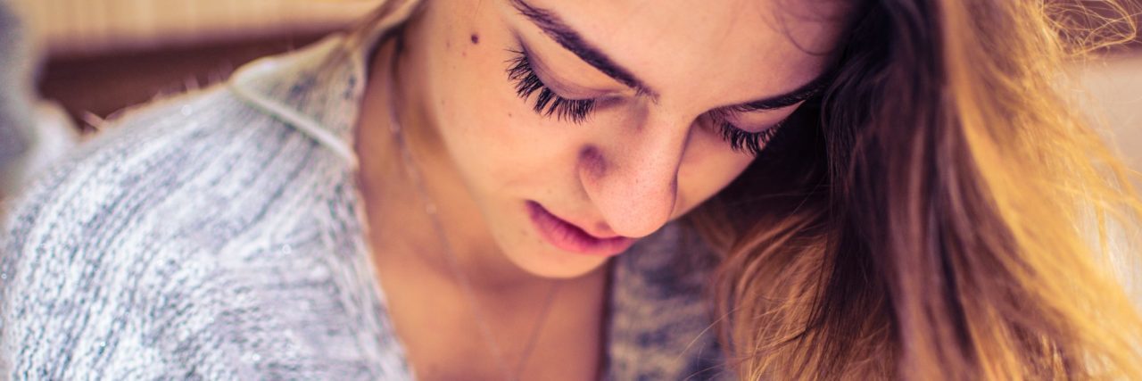 I Wonder What It's Like Not to Be So Hyper-Vigilant: A Poem young blonde woman holding necklace looking down