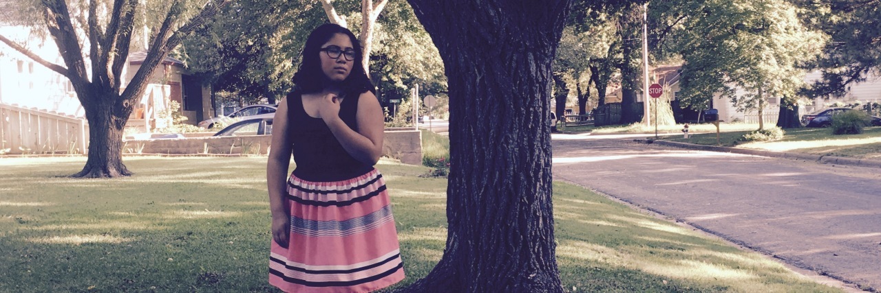 How I'm Learning to Trust My Journey With Rare Disease woman standing under a tree