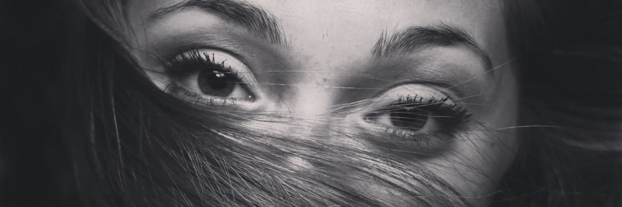 How Love Saved Me From Choosing Suicide woman in black and white with face covered by hair