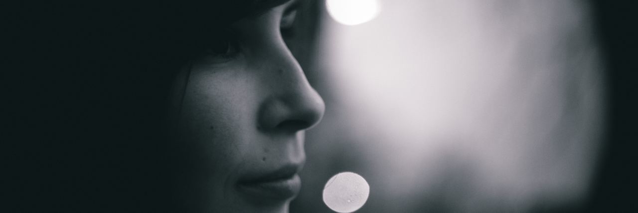 How My Anxiety Both Hurts and Empowers Me woman in shadow looking to the side