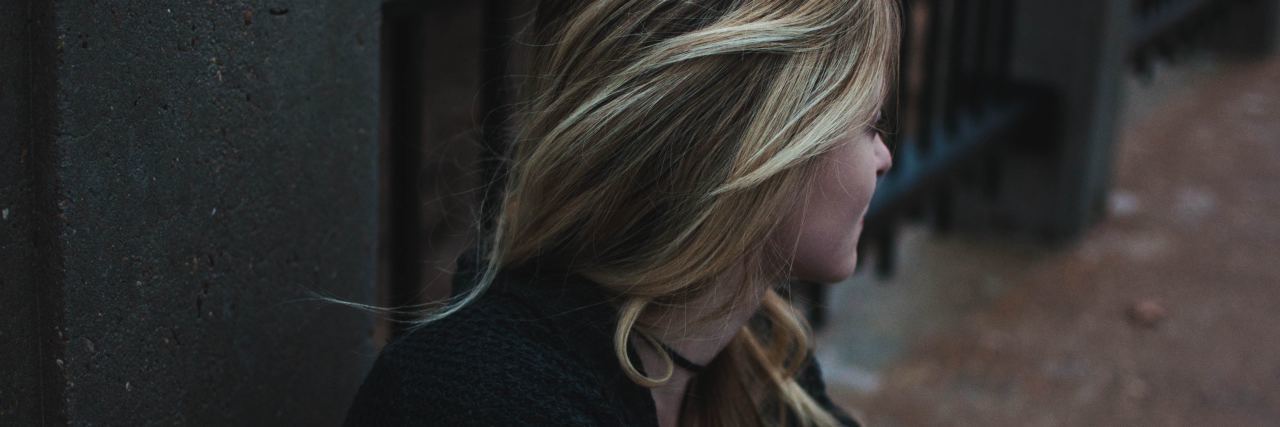 Comparing Yourself to Others in Eating Disorder Recovery A woman looking away and sitting down