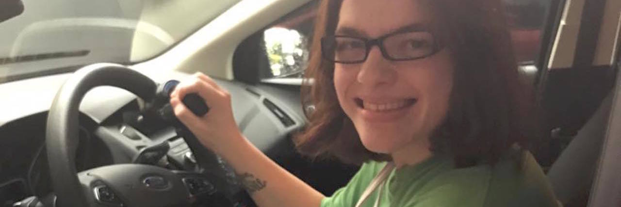 woman sitting in the driver's seat of a car