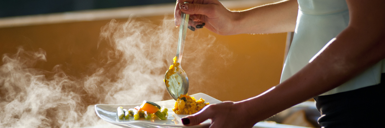 The 5 Stages of My Relationship With Food After ME/CFS woman serving herself food