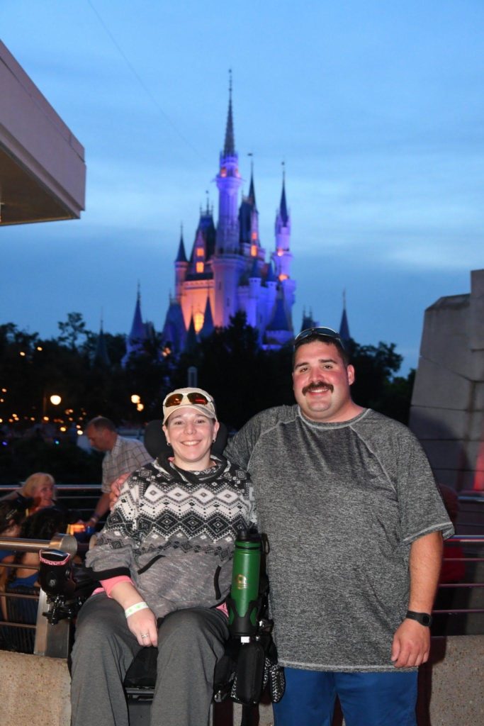 My husband and I at Walt Disney World waiting to watch the fireworks with the Castle in the background.
