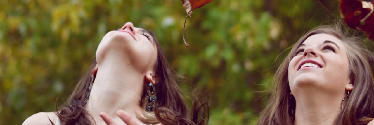 5 Things My Best Friend Who Recovered From Anorexia Teaches Me two best friends stand looking up as they throw leaves into the air
