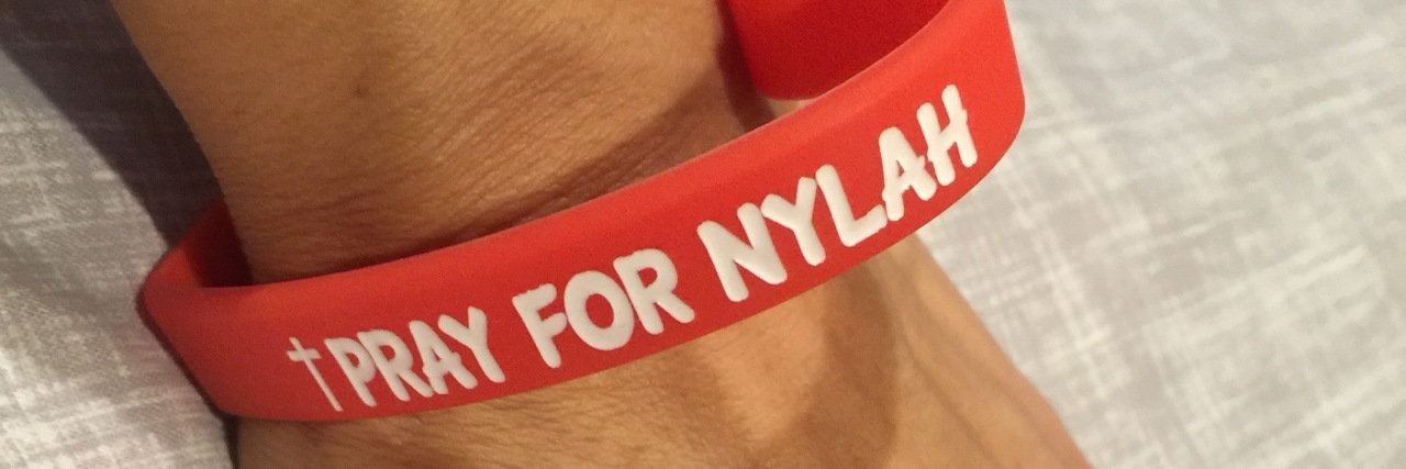 Things I've Been Told to Expect Once My 'Heart Baby' Is Born Red heart bracelet reads, "Pray for Nylah"