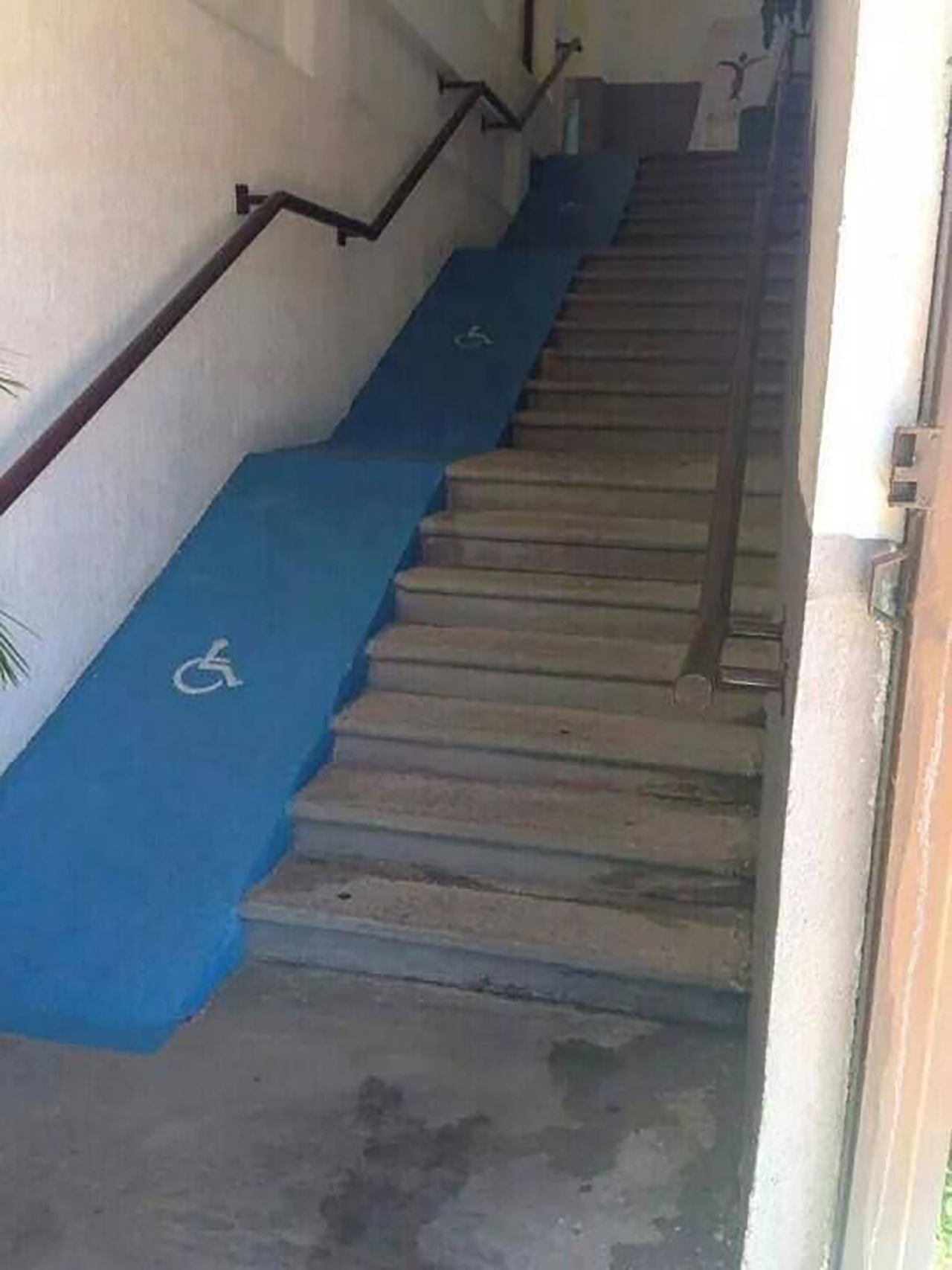 Terrible ramp alongside stairs that no one in a wheelchair could actually use.
