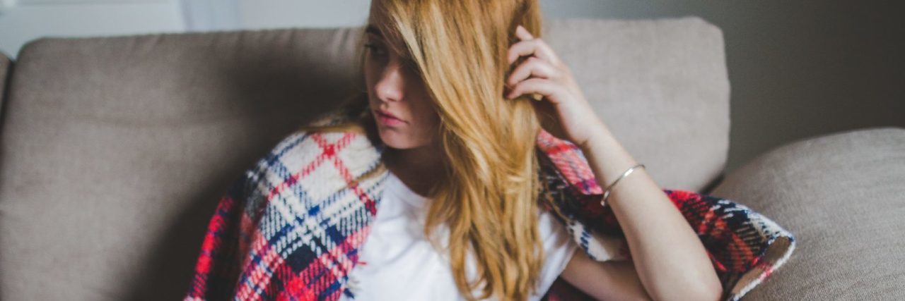 How My Teacher Helped My Self-Esteem young woman looking depressed sitting on sofa