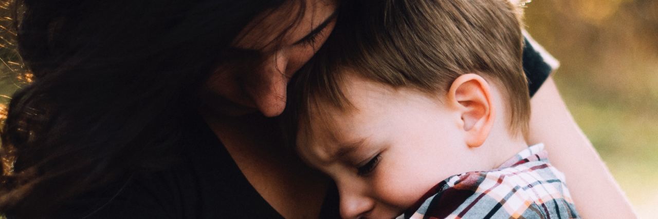 To the Sons Who Embrace Every Version of Their Bipolar Mama a mom holds her son in her arms