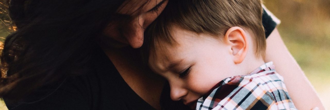 How to Deal With Depression as a Parent mother hugging young son both looking upset