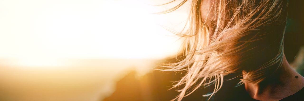 Reasons I'm Glad I Didn't End My Life to Suicide young woman with blonde hair at sunset looking peaceful