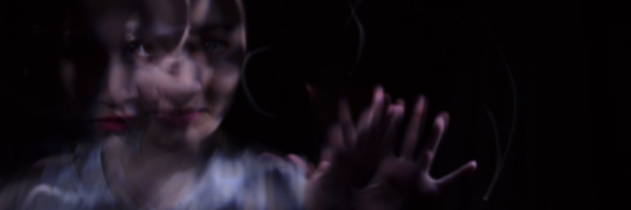 5 Surprising Physical Symptoms of Post-Traumatic Stress Disorder double exposure of woman reaching out to camera