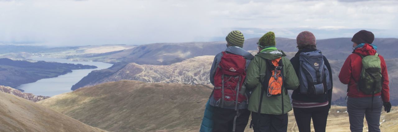 5 Ways to Help Your Family Better Understand Your Mental Health Needs group of 4 adults standing at the top of a hill they have just hiked