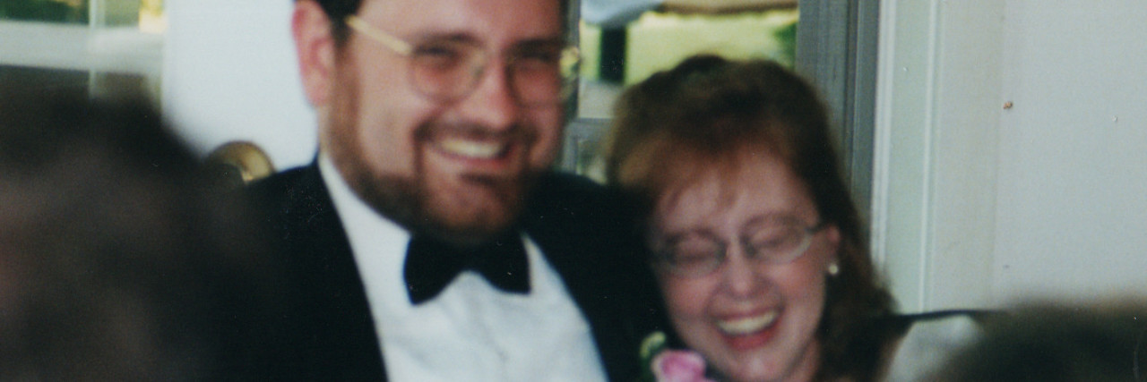 Why It's OK That Juvenile Rheumatoid Arthritis Has Shaped My Life couple at wedding laughing