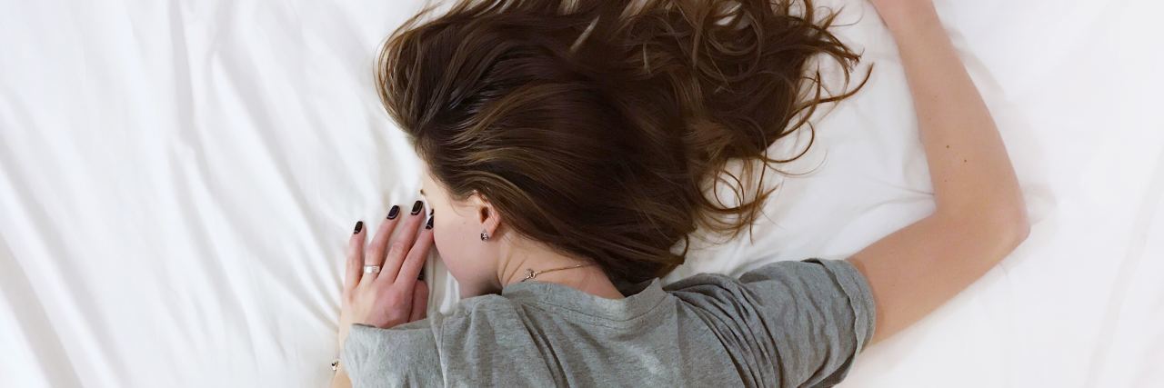 The Hidden Ways My Depression, OCD, ADHD, and Anxiety Affect Me upset woman lying face down in bed upset