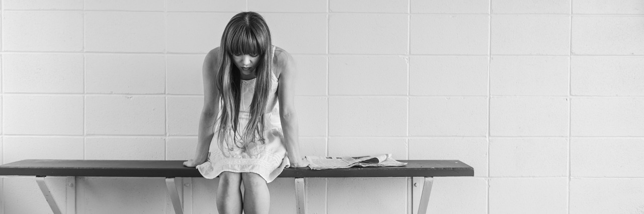 Short Bowel Syndrome: Going Through 5 Stages of Grief After Diagnosis black and white photo of a woman sitting on a bench