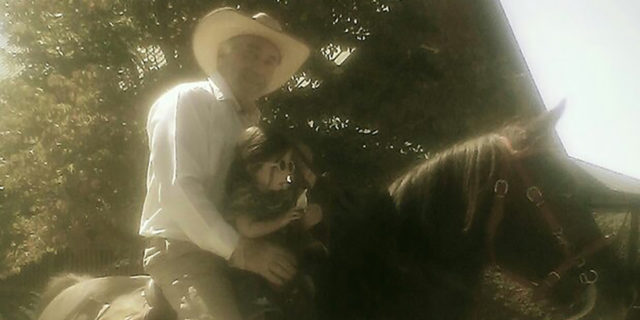 Julia Trecanao's father with her daughter, riding a horse.