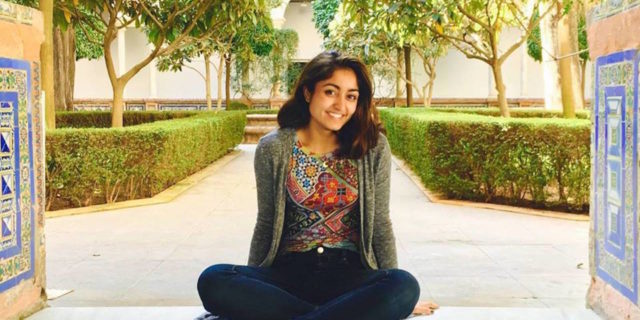 woman sitting outside and smiling