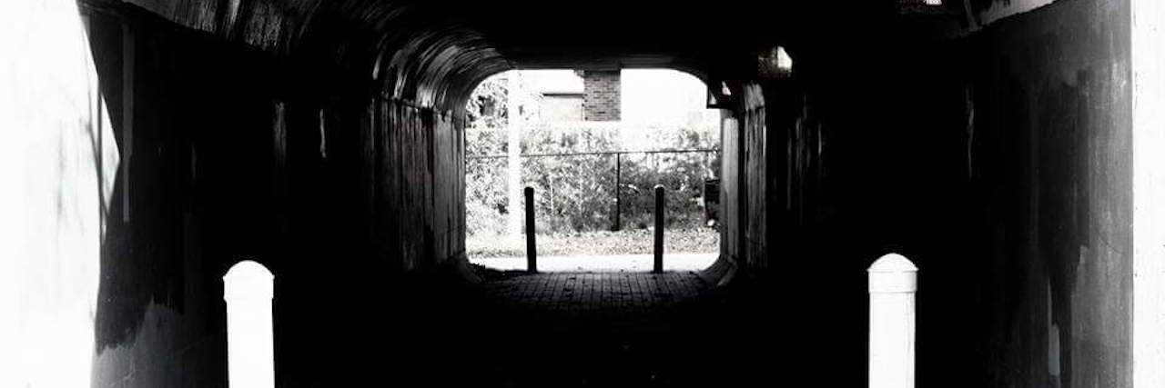 How to Cope With the Isolation of Chronic Illness black and white photo of a tunnel by the author