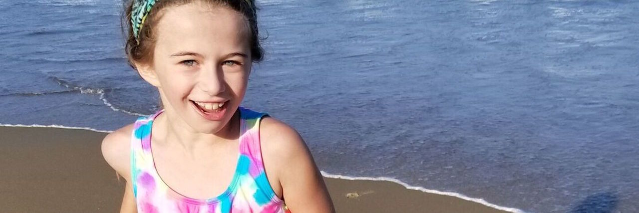 young girl playing on the beach