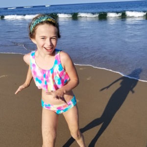 young girl playing on the beach