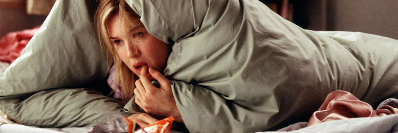 What Happens During a Flare-Up of Arthritis, Ankylosing Spondylitis bridget jones curled up in bed eating snacks