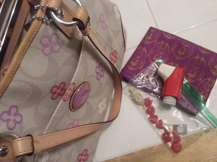 floral bag with medications in plastic bag