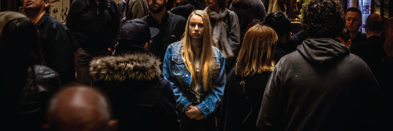 29 Things People Said That Were Actually Code for 'I'm Anxious' woman stands in the middle of a crowd
