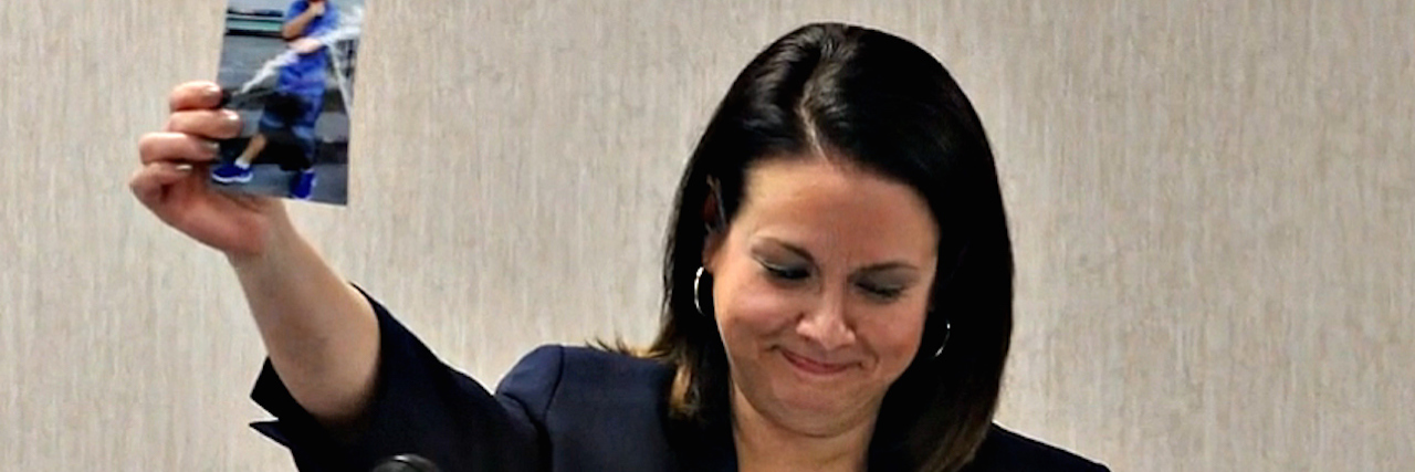 Why I'm an 'Accidental' Mental Health Advocate A woman holding up a photo of her son