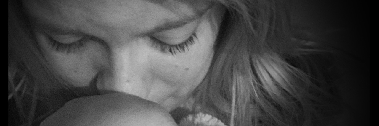 5 Things to Remember When You Feel Guilty for Being Ill The writer looking down, with a solemn expression. The image is black and white.