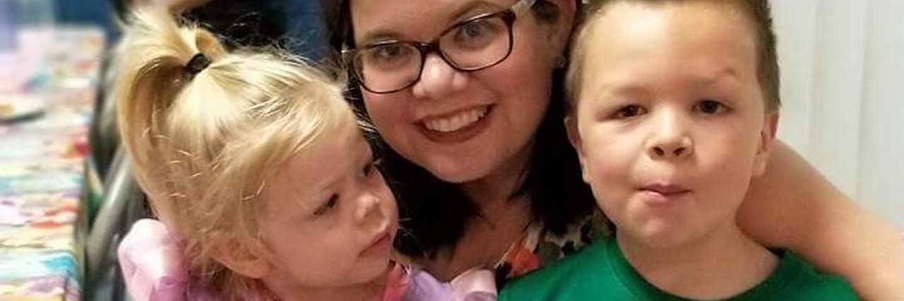 How My Fear of Vomiting Makes Parenting a Challenge mother hugging two children