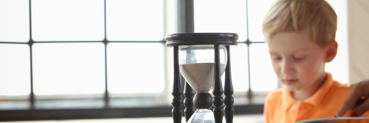 Tips to Improve Executive Functioning in Your Child Boy with timer doing homework