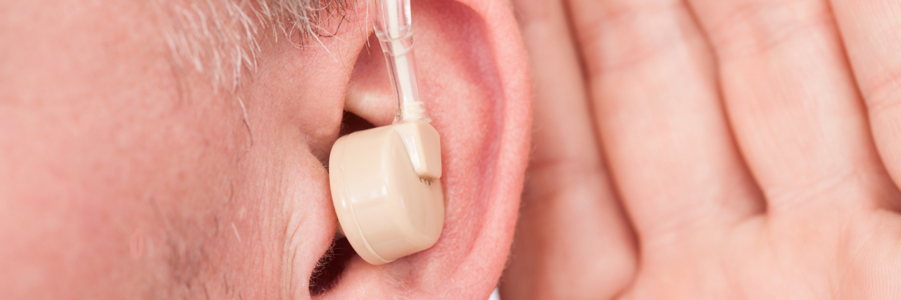 Humor for People With Hearing Loss Older man wearing hearing aid.