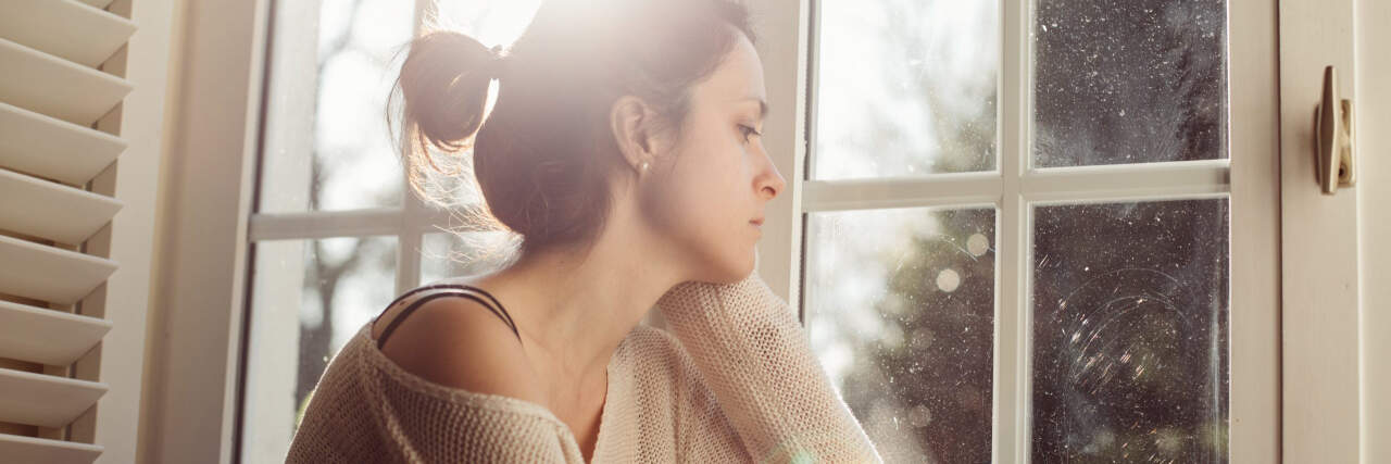 Sick of Being Sick With Fibromyalgia, Chronic Illness woman looking sad in front of a window