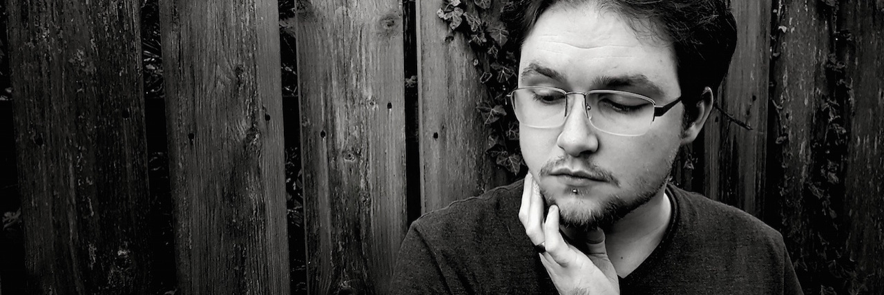 How Anxiety Made Me Avoid a Lump for 15 Years a man touching his neck