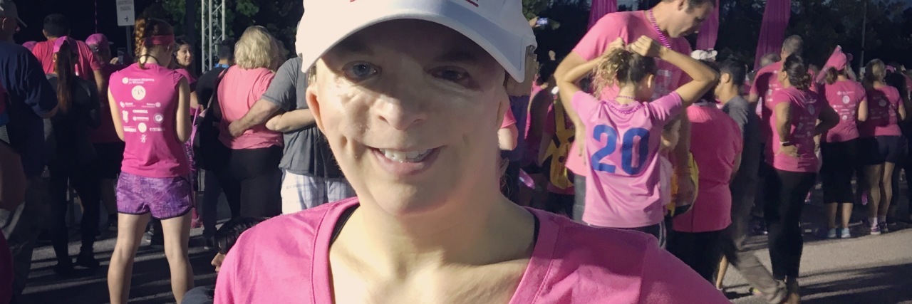 Life Lessons I've Learned From Treacher Collins Syndrome woman at a race wearing a pink shirt that says 'be brave, be strong, be fearless'