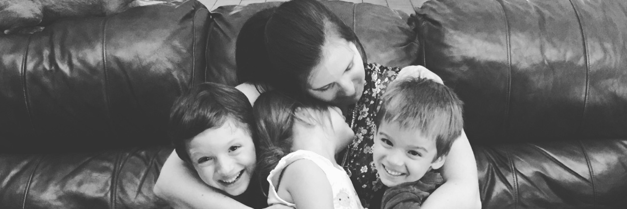 I Lost Myself in My Role as a Parent Black and white picture of mother holding her three children