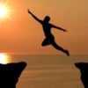 man jumping between cliffs in a 'leap of faith'