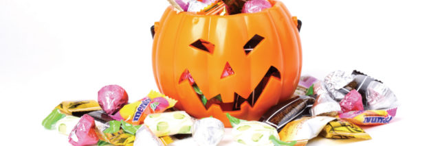 pumpkin halloween bucket with candy overflowing from it