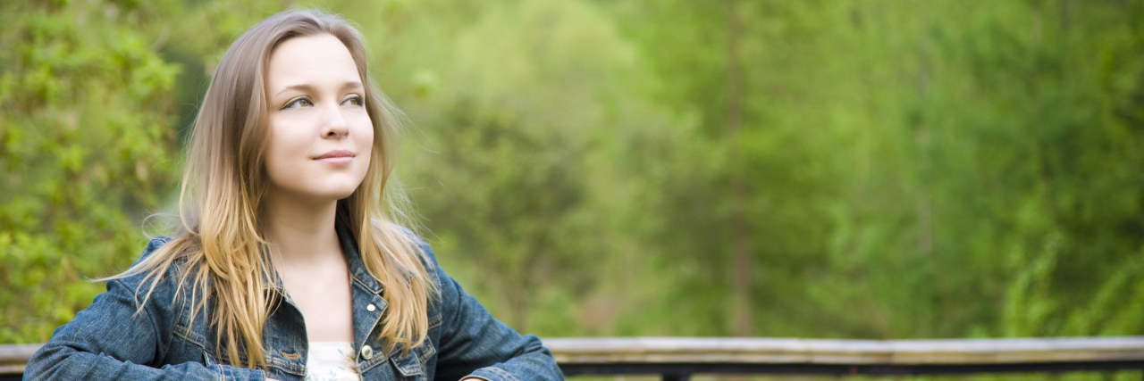 Planning for the Future With Ehlers-Danlos Syndrome (EDS) woman standing on a bridge smiling