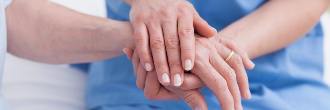 Acts of Kindness From Medical Professionals in the NHS nurse holding a patient's hand