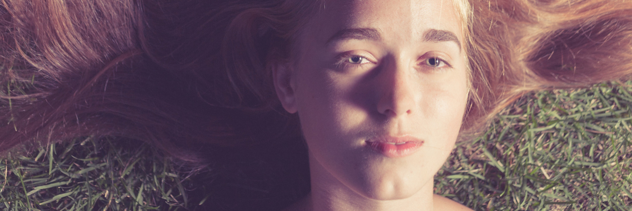 Answers to Common Anxiety Misconceptions woman lying in the grass